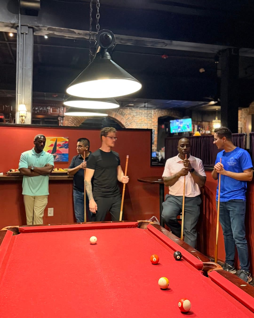 Builders Night guests chatting around the pool table